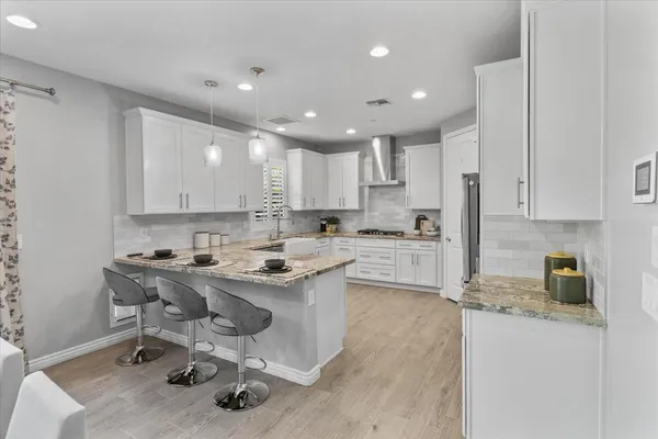a kitchen with a sink a stove a refrigerator and cabinets
