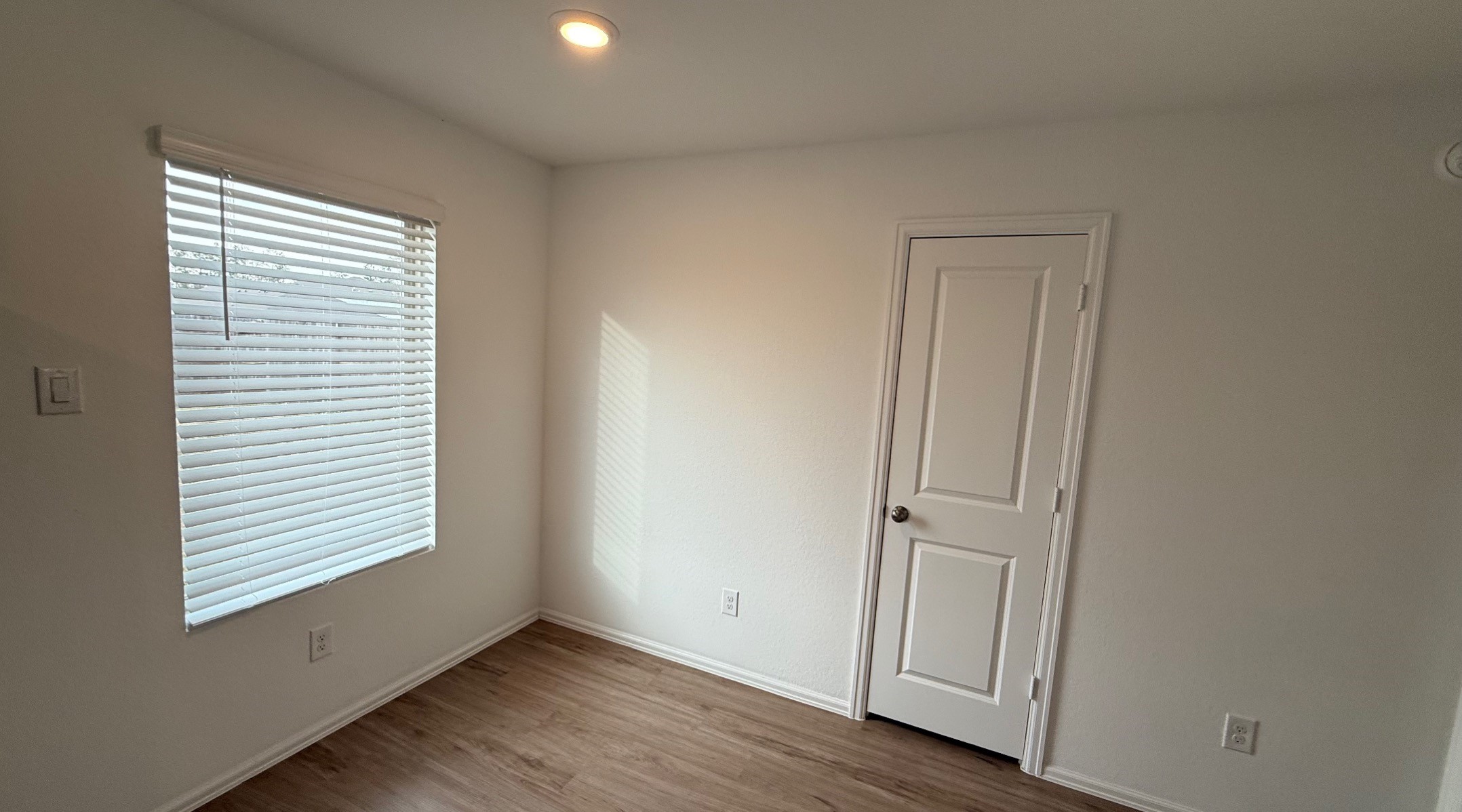 18926 Panzini Drive New Caney, TX 77357 - Photo 22 of 23 an empty room with wooden floor and windows