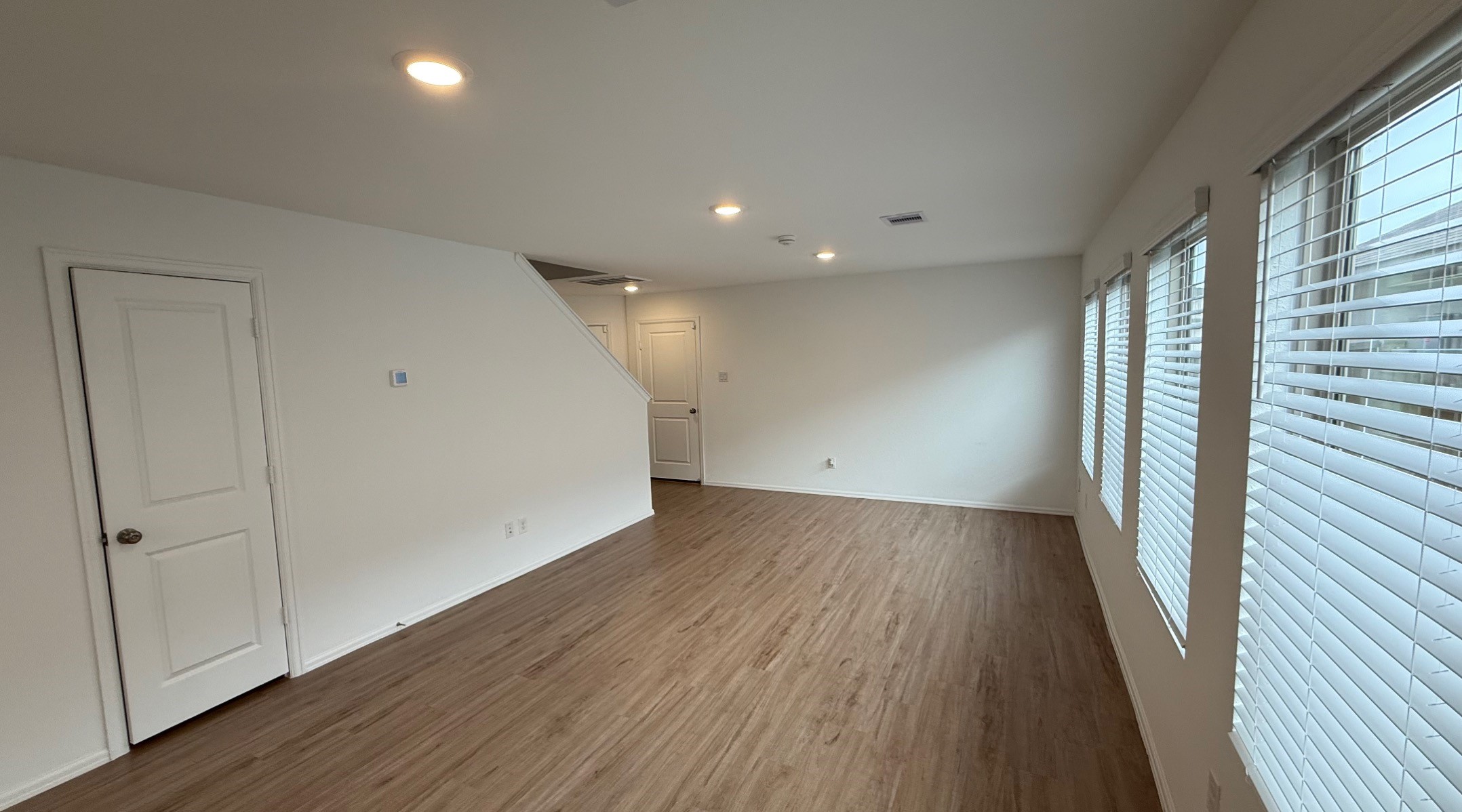 18926 Panzini Drive New Caney, TX 77357 - Photo 4 of 23 an empty room with wooden floor and windows