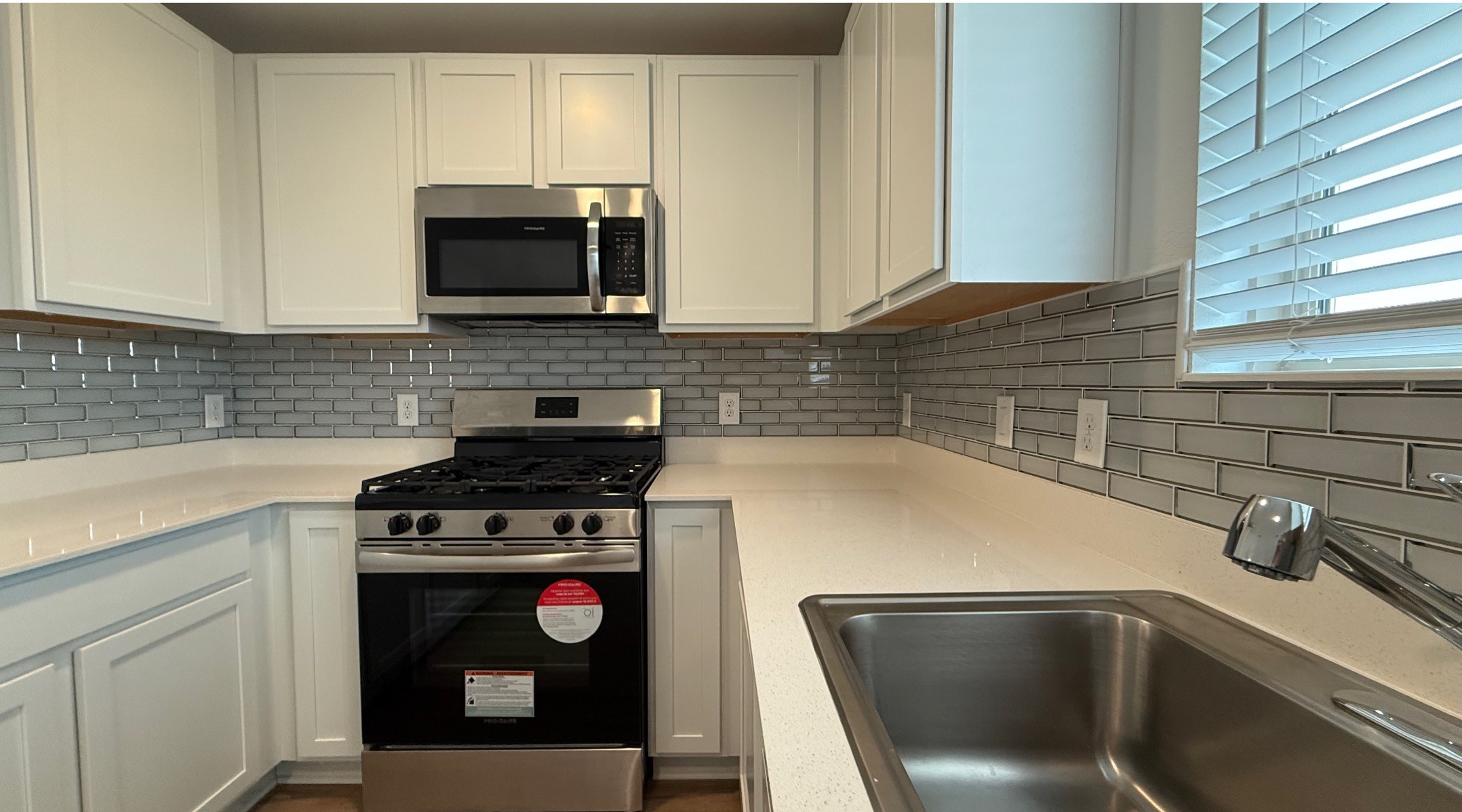 18926 Panzini Drive New Caney, TX 77357 - Photo 8 of 23 a kitchen with a sink and a stove top oven