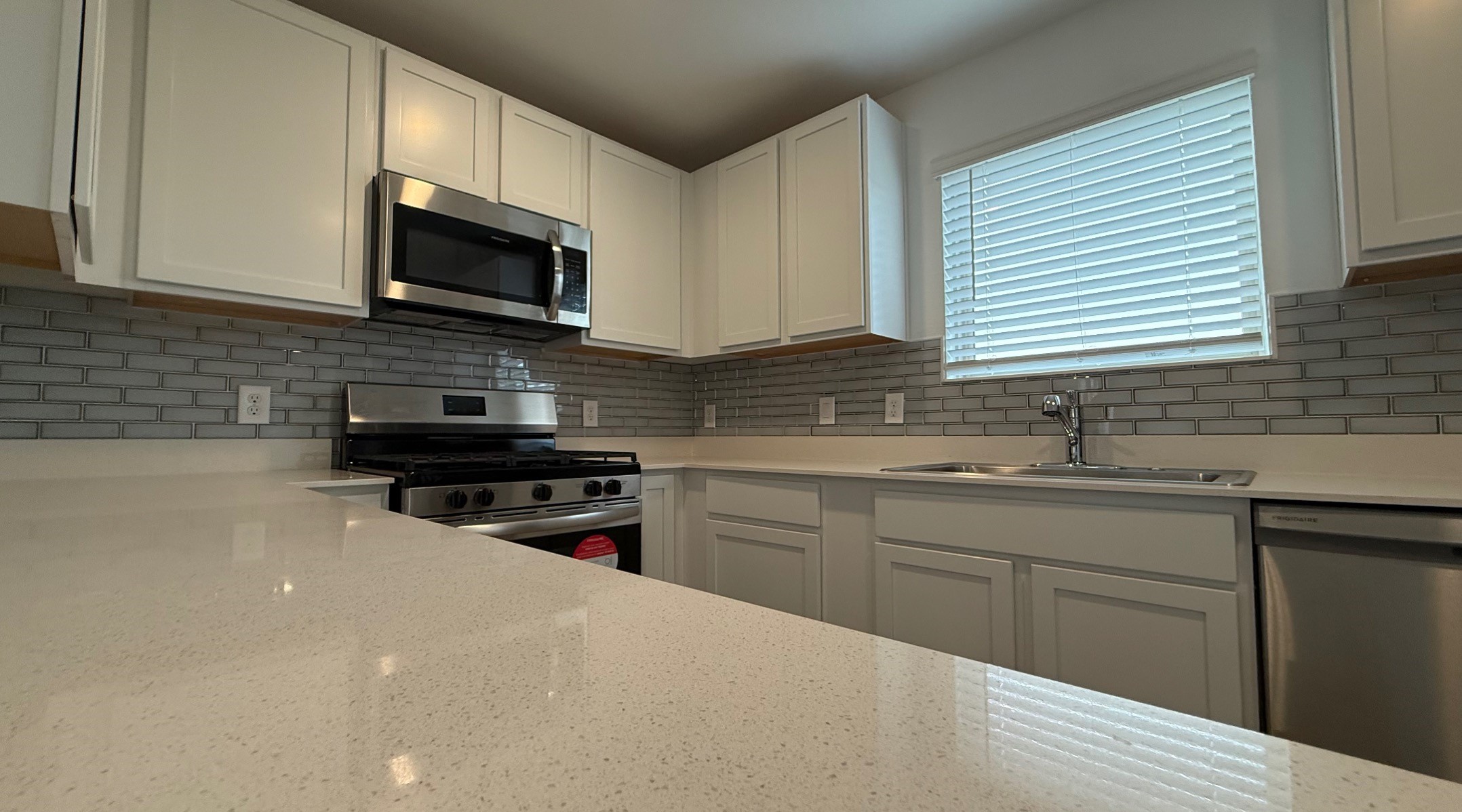 18926 Panzini Drive New Caney, TX 77357 - Photo 9 of 23 a kitchen with stainless steel appliances granite countertop white cabinets granite counter tops and a window