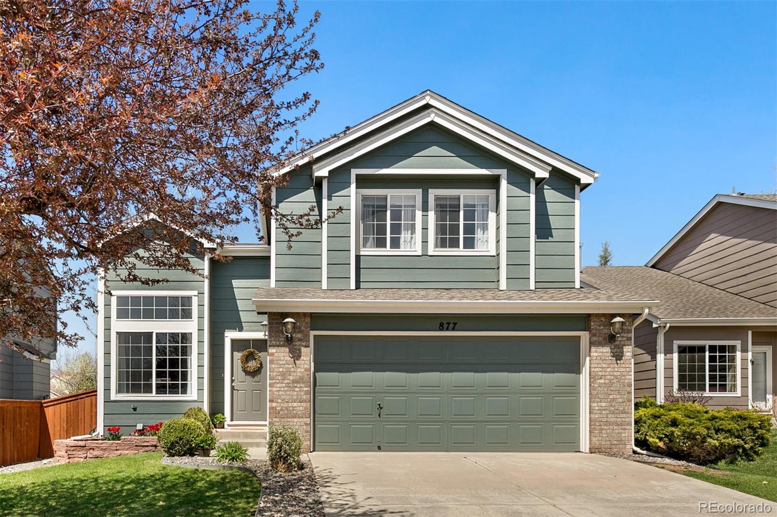 877 Timbervale Trail Highlands Ranch, CO 80129 - Photo 1 of 34 a front view of a house with a yard