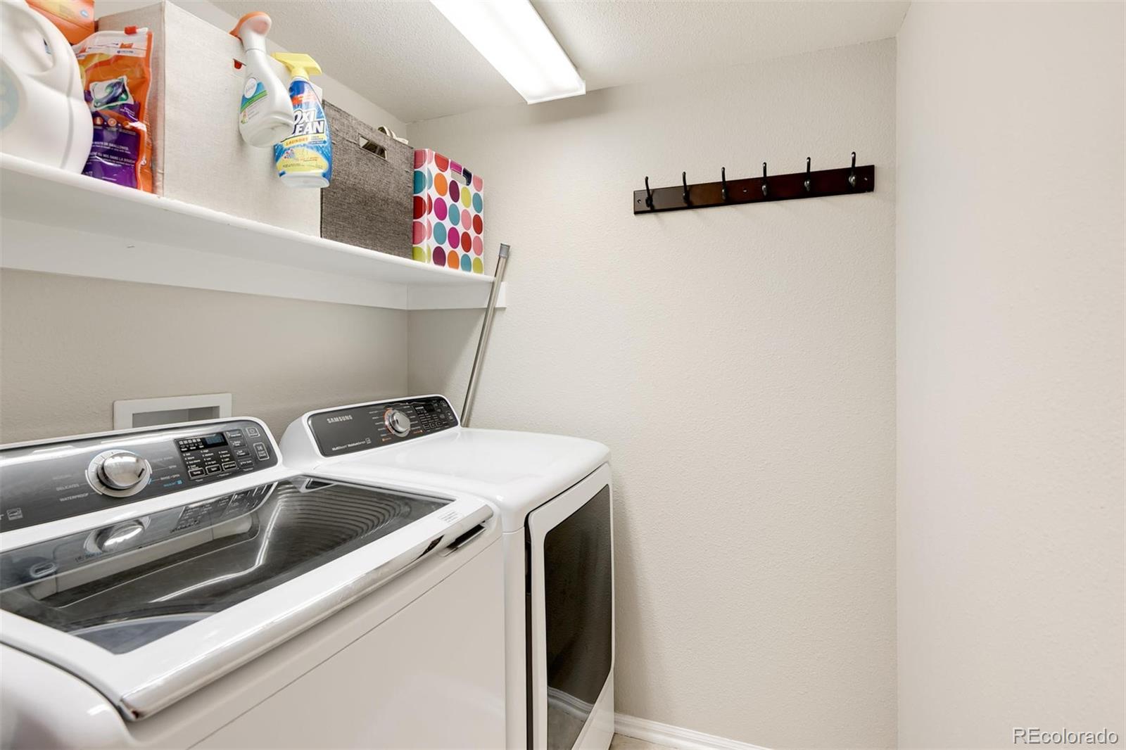 877 Timbervale Trail Highlands Ranch, CO 80129 - Photo 14 of 34 a utility room with dryer and washer