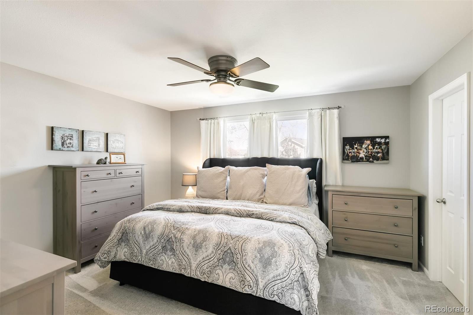 877 Timbervale Trail Highlands Ranch, CO 80129 - Photo 18 of 34 a bedroom with a bed and a dresser
