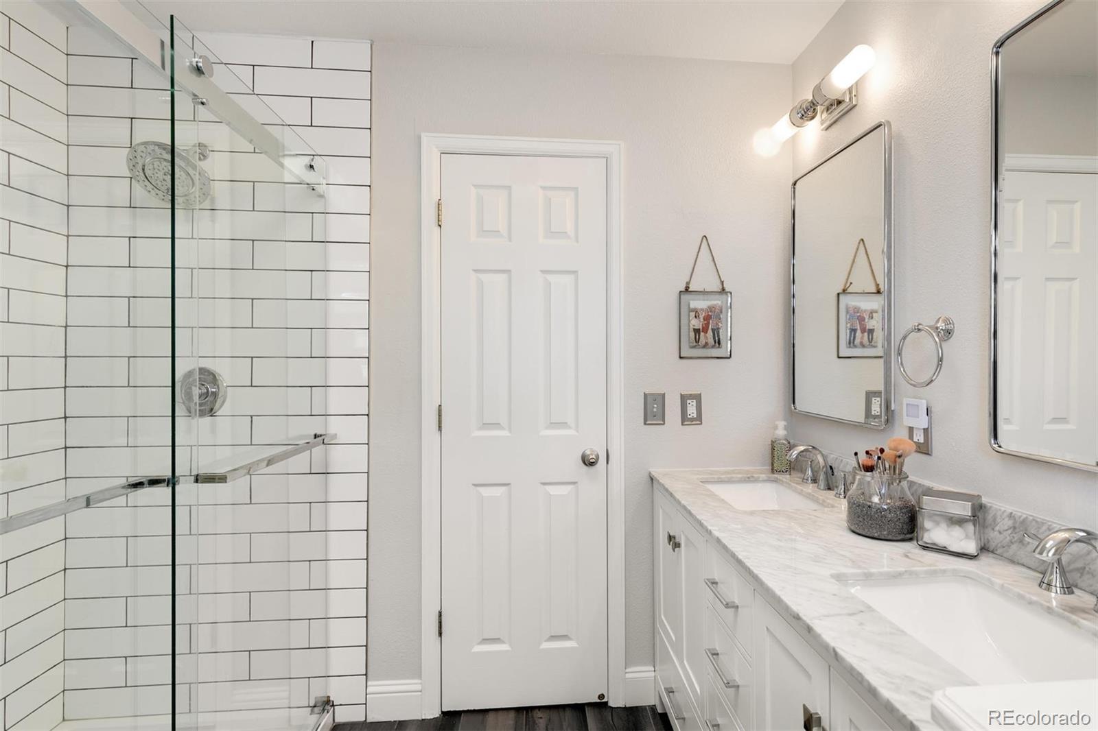 877 Timbervale Trail Highlands Ranch, CO 80129 - Photo 20 of 34 a bathroom with a granite countertop shower sink and mirror