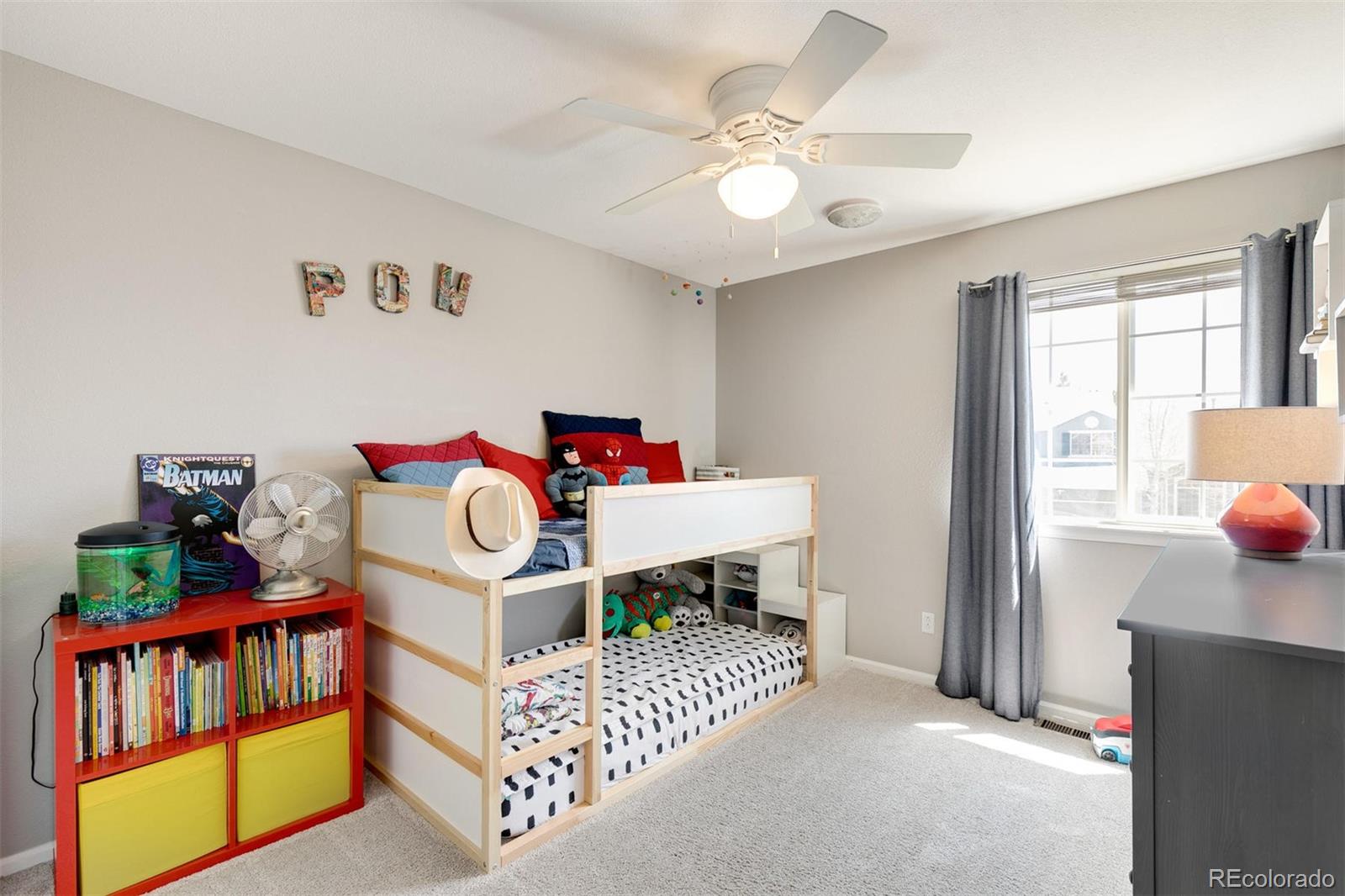 877 Timbervale Trail Highlands Ranch, CO 80129 - Photo 21 of 34 a bedroom with furniture and a chandelier