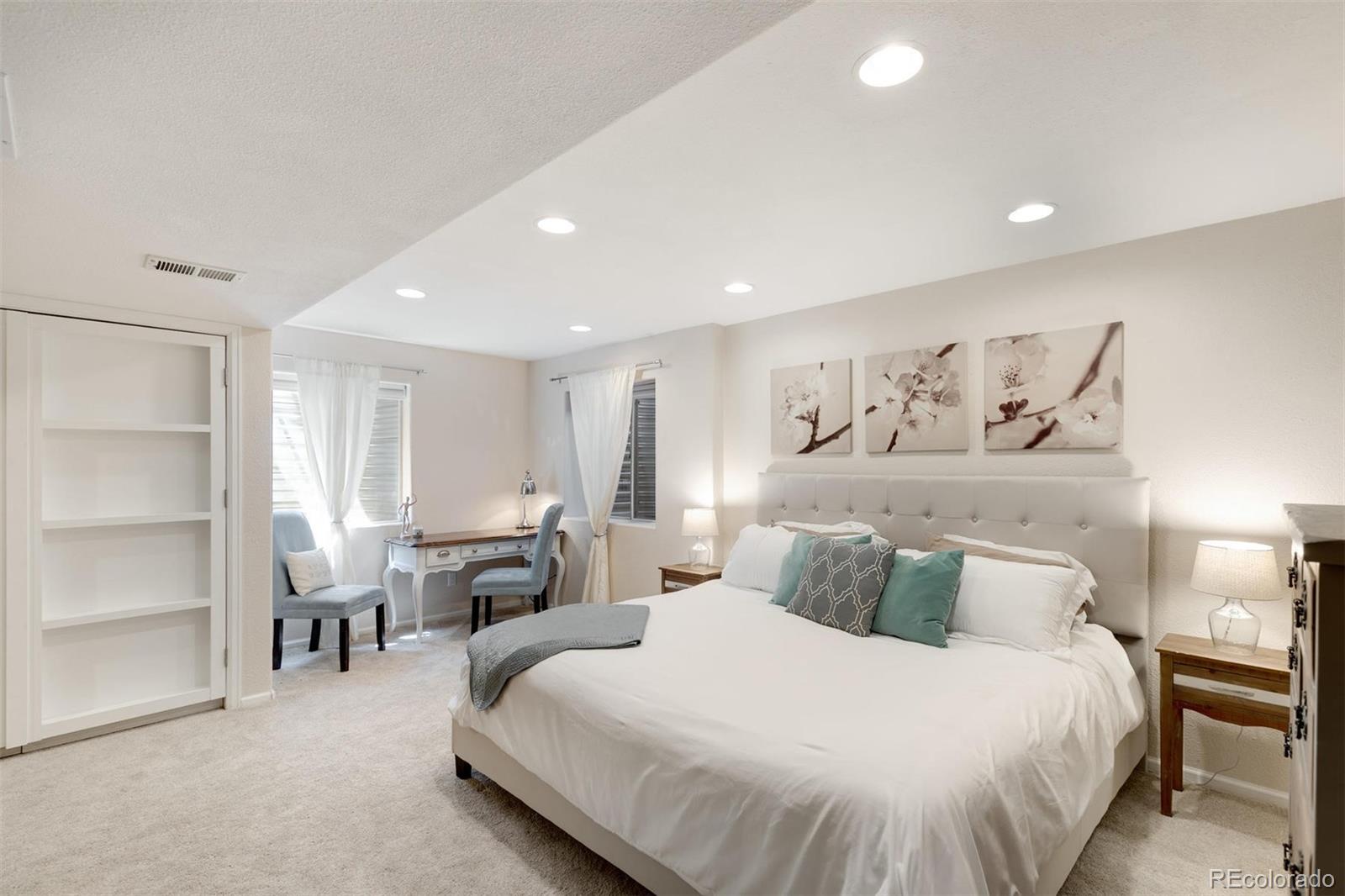 877 Timbervale Trail Highlands Ranch, CO 80129 - Photo 24 of 34 a bedroom with a bed and a large mirror