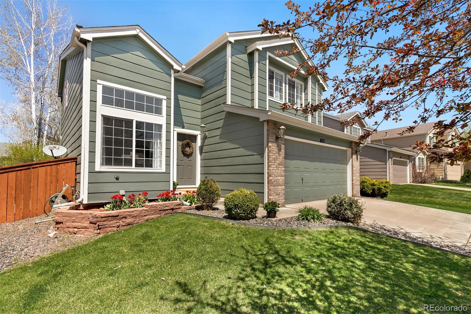 877 Timbervale Trail Highlands Ranch, CO 80129 - Photo 34 of 34 a front view of a house with garden