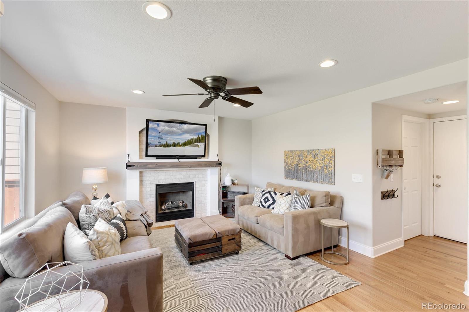 877 Timbervale Trail Highlands Ranch, CO 80129 - Photo 5 of 34 a living room with furniture and a fireplace