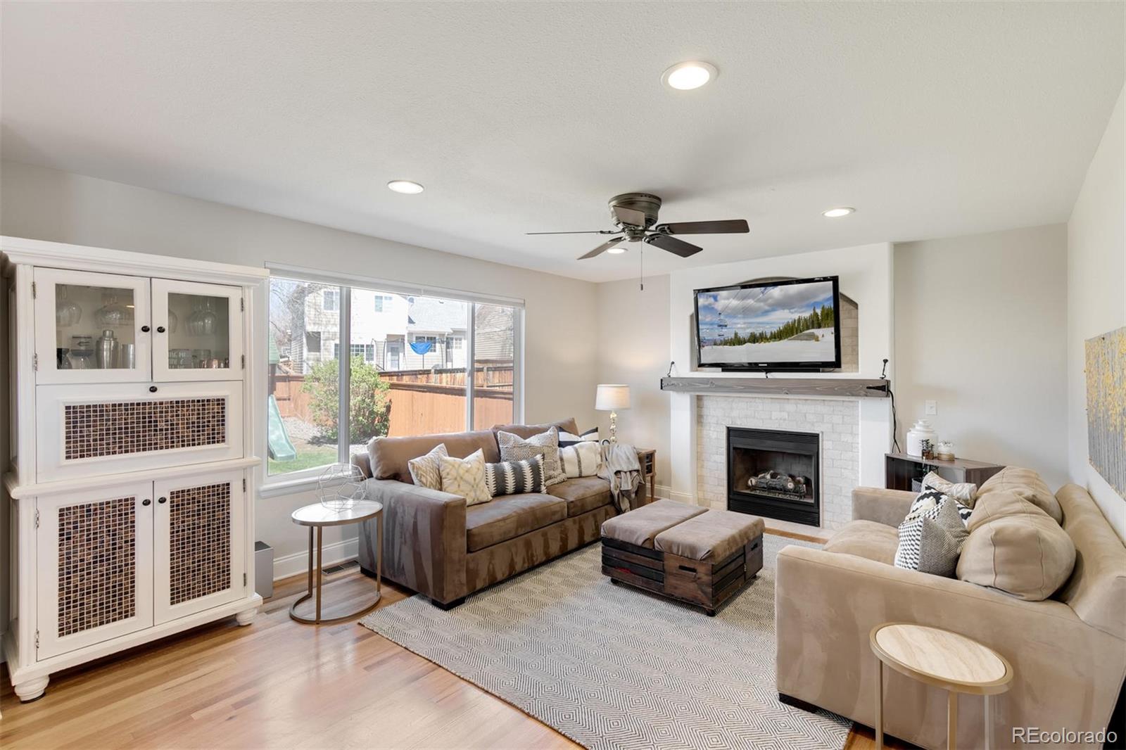 877 Timbervale Trail Highlands Ranch, CO 80129 - Photo 6 of 34 a living room with furniture or chandelier and a fireplace