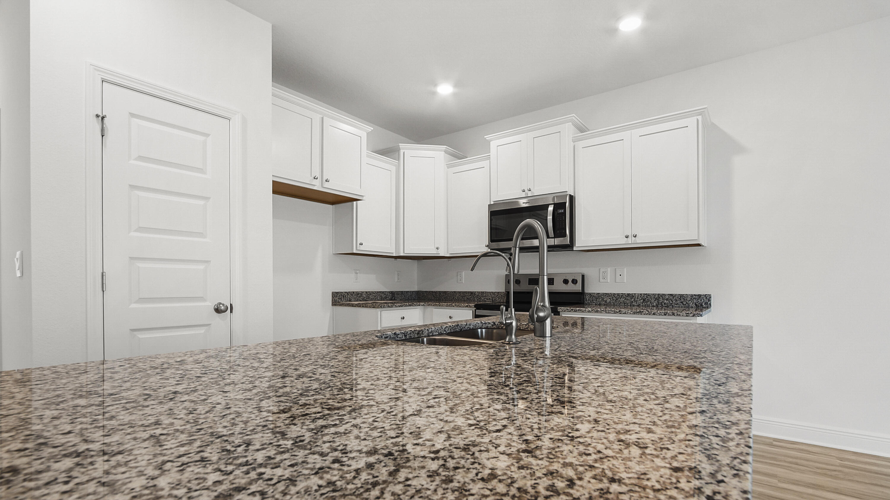 30 Phoenix Street Santa Rosa Beach, FL 32459 - Photo 11 of 34 a kitchen with granite countertop a sink a stove and cabinets