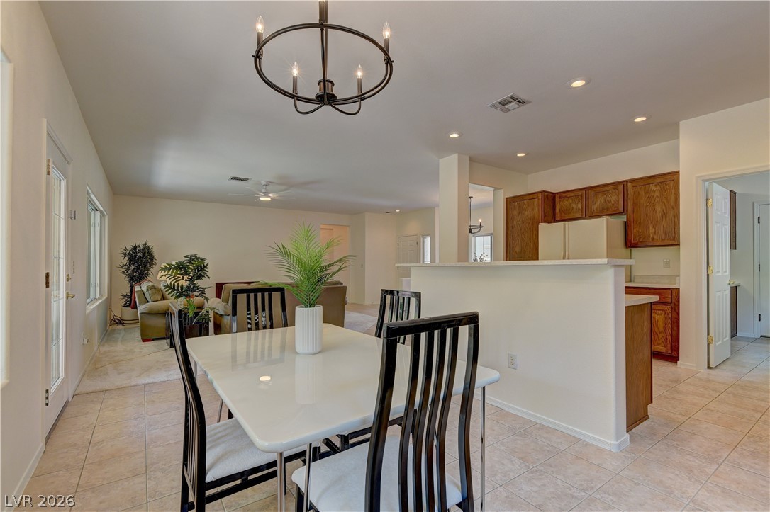 3013 Fort Stanwix Road Henderson, NV 89052 - Photo 12 of 26 Dining space with hanging lights and light tile patterned flooring