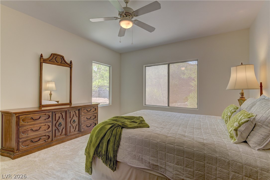 3013 Fort Stanwix Road Henderson, NV 89052 - Photo 17 of 26 Carpeted bedroom with a ceiling fan and multiple windows