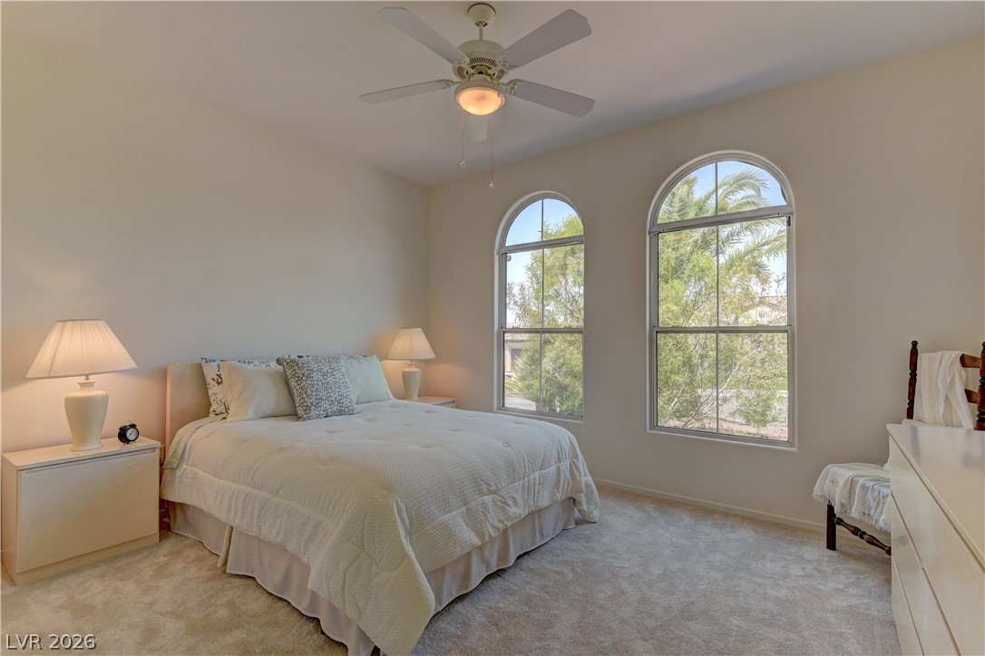 3013 Fort Stanwix Road Henderson, NV 89052 - Photo 20 of 26 Bedroom with light colored carpet and ceiling fan
