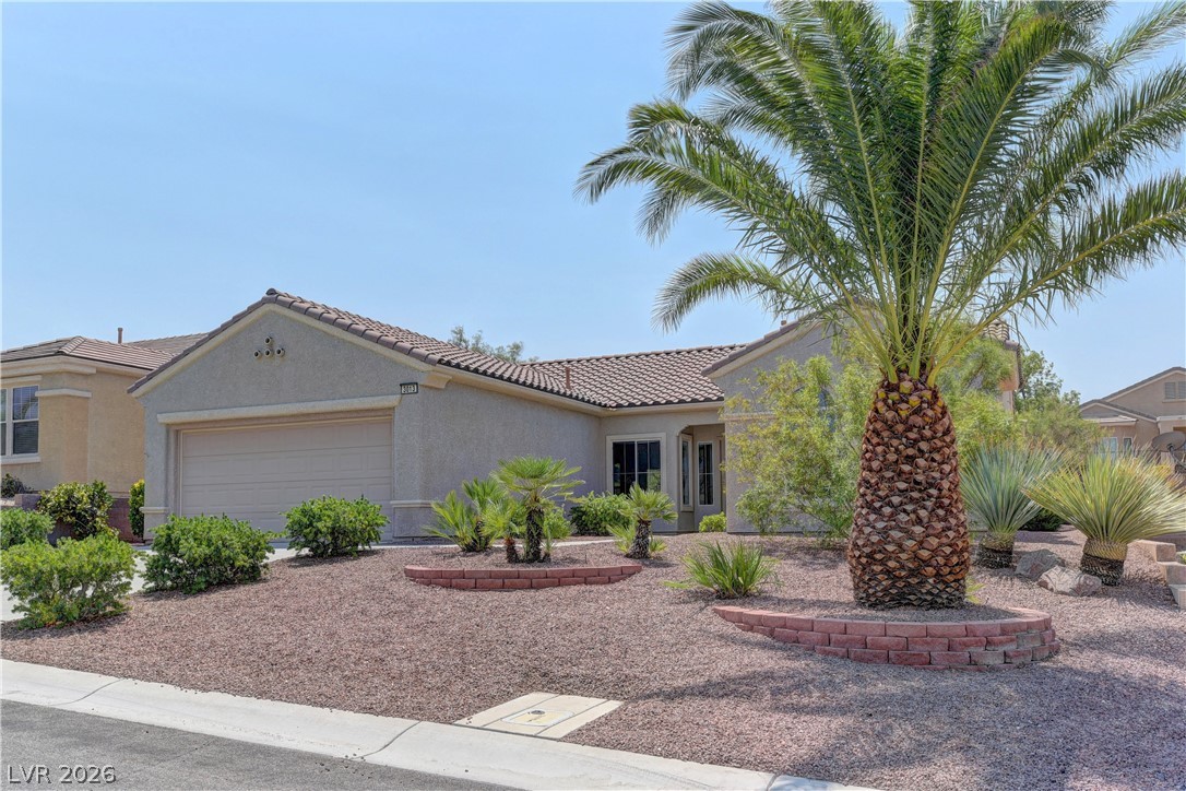 3013 Fort Stanwix Road Henderson, NV 89052 - Photo 2 of 26 View of front of house featuring stucco siding, an attached garage, and a tiled roof
