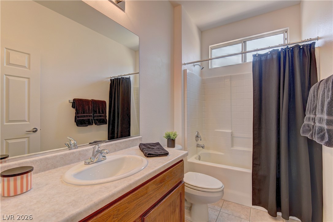 3013 Fort Stanwix Road Henderson, NV 89052 - Photo 22 of 26 Bathroom featuring shower / bath combo, vanity, and light tile patterned floors