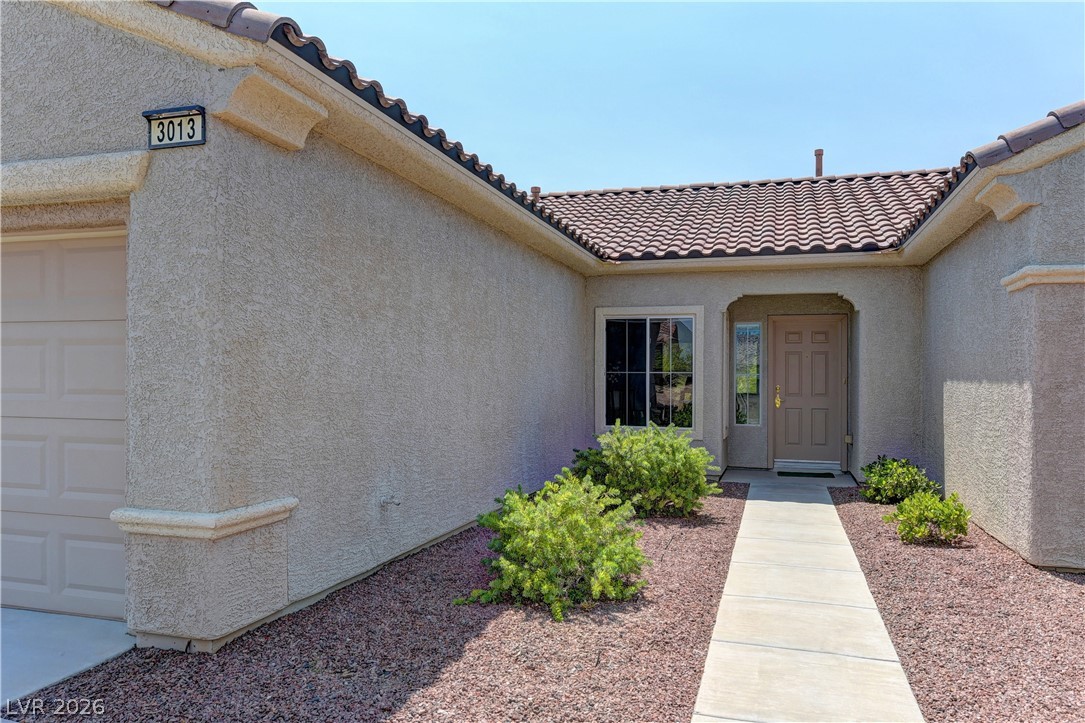 3013 Fort Stanwix Road Henderson, NV 89052 - Photo 3 of 26 Doorway to property featuring a tile roof and a garage