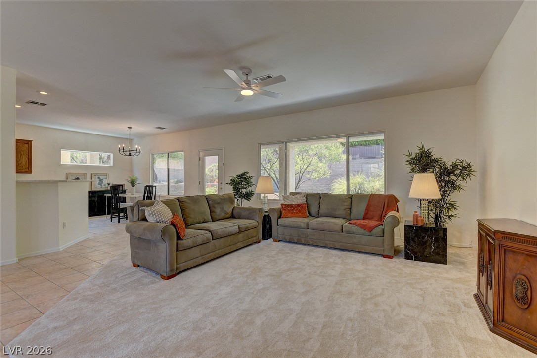 3013 Fort Stanwix Road Henderson, NV 89052 - Photo 4 of 26 Living area featuring a ceiling fan, suspended lighting, and light tile patterned flooring