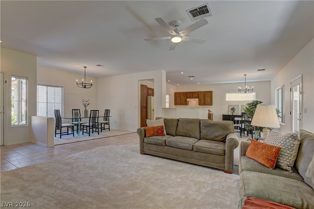 3013 Fort Stanwix Road Henderson, NV 89052 - Photo 5 of 26 Carpeted living area with suspended lighting, healthy amount of natural light, and a ceiling fan