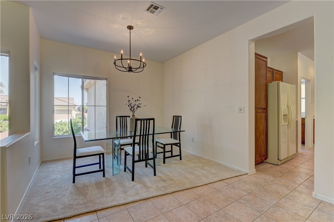 3013 Fort Stanwix Road Henderson, NV 89052 - Photo 7 of 26 Dining area with hanging lights and light tile patterned floors