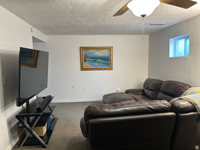 7659 State Street Midvale, UT 84047 - Photo 20 of 33 Living area with carpet floors, a textured ceiling, and a ceiling fan