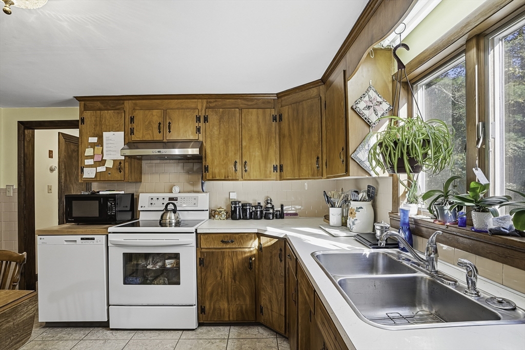 39 Mechanic Street Upton, MA 01568 - Photo 8 of 35 a kitchen with a sink stove and cabinets