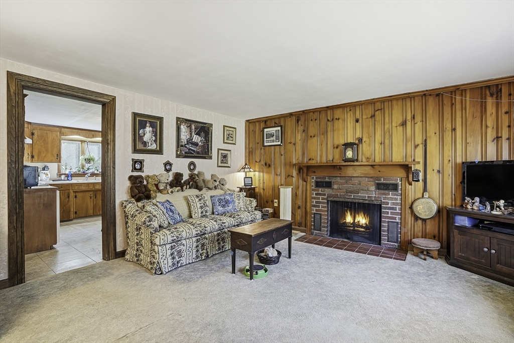 39 Mechanic Street Upton, MA 01568 - Photo 10 of 35 a living room with furniture and a fireplace