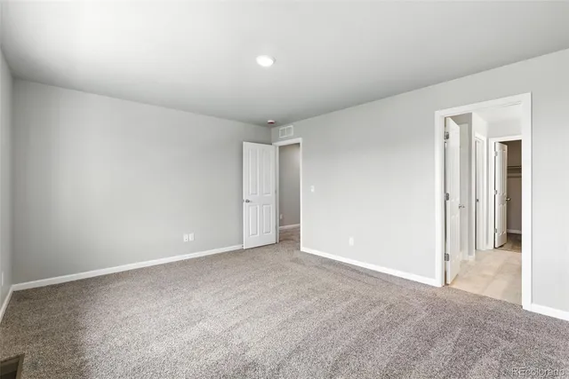 a view of an empty room and closet area