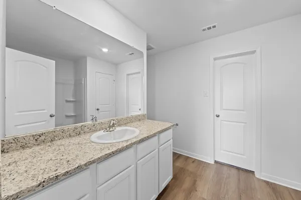a bathroom with a granite countertop sink and a mirror
