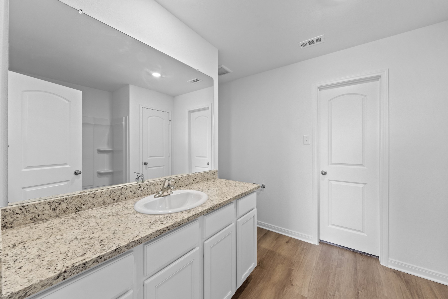 314 Low Pasture Trail Maxwell, TX 78656 - Photo 6 of 10 a bathroom with a granite countertop sink and a mirror