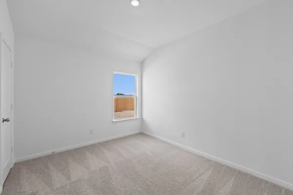 a view of an empty room and a window
