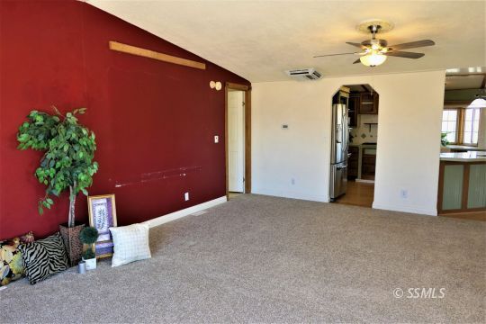 400 South Guam Street Ridgecrest, CA 93555 - Photo 3 of 39 a big room with closet and a chandelier fan