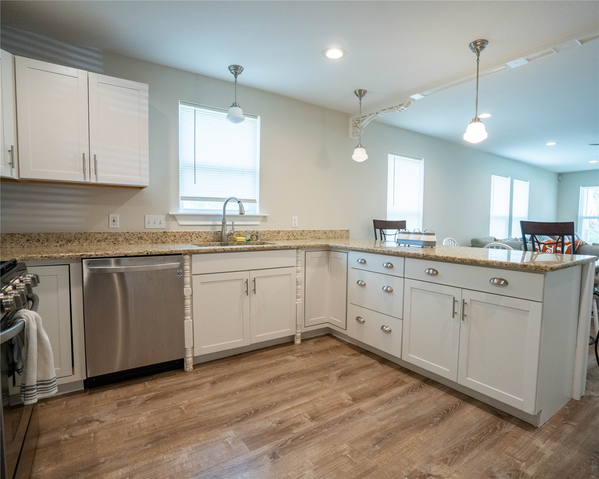 404 Rivers Street Smithville, TX 78957 - Photo 15 of 27 Kitchen featuring wood-finish flooring and light-toned cabinetry