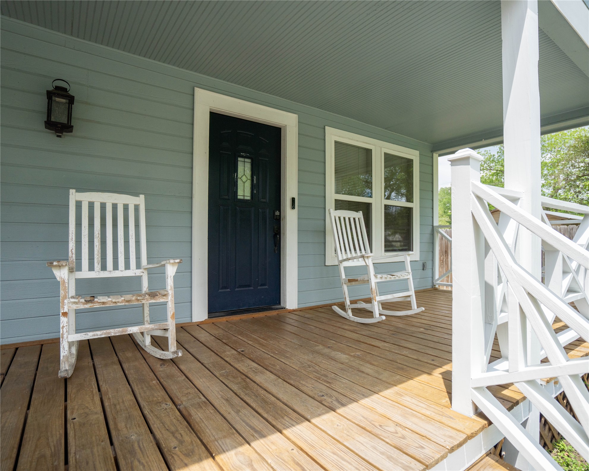 404 Rivers Street Smithville, TX 78957 - Photo 2 of 27 Expansive wood-finish front porch with light blue siding