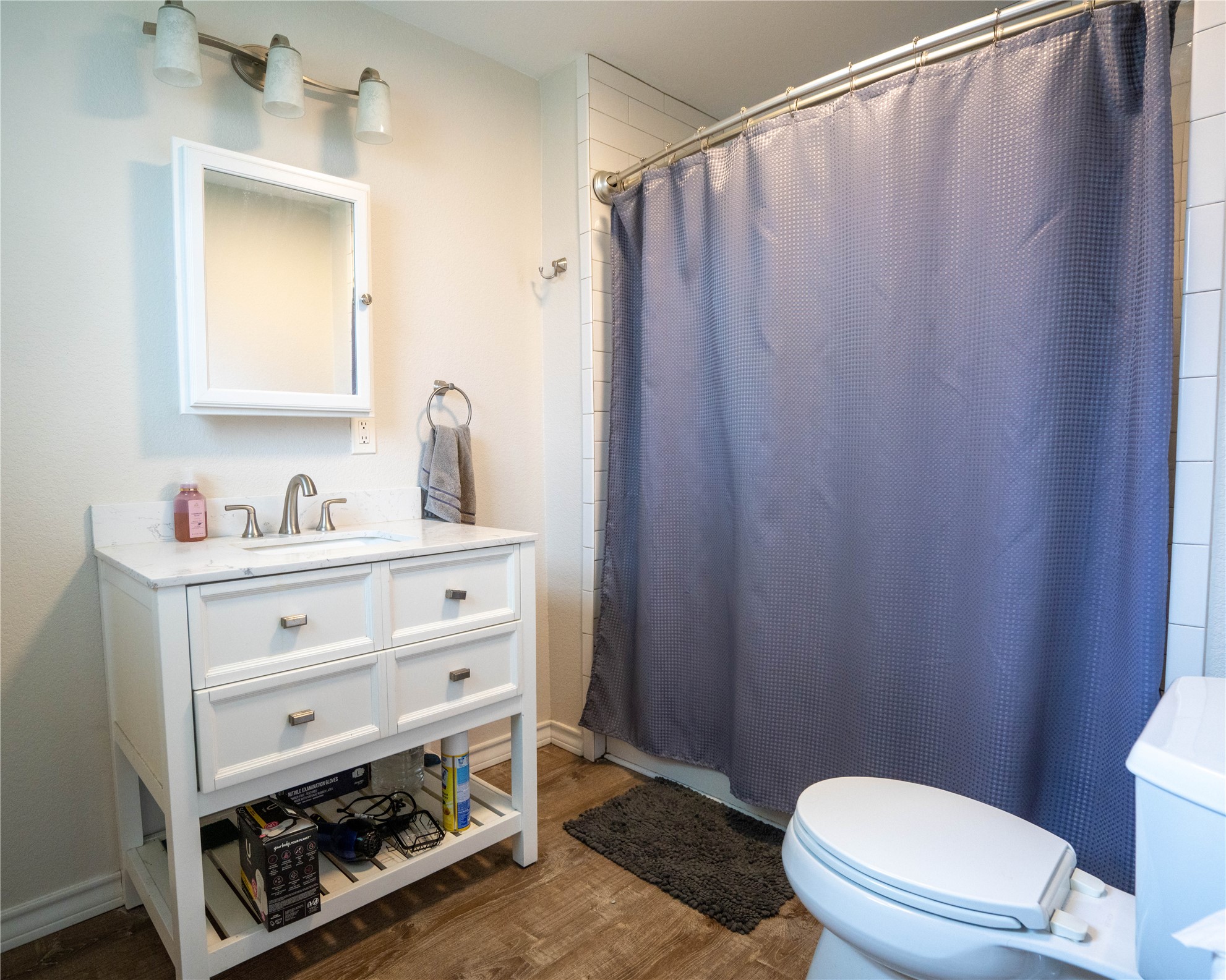 404 Rivers Street Smithville, TX 78957 - Photo 7 of 27 Bathroom featuring a white vanity with integrated sink, brushed nickel faucet, and a wall-mounted medicine cabinet