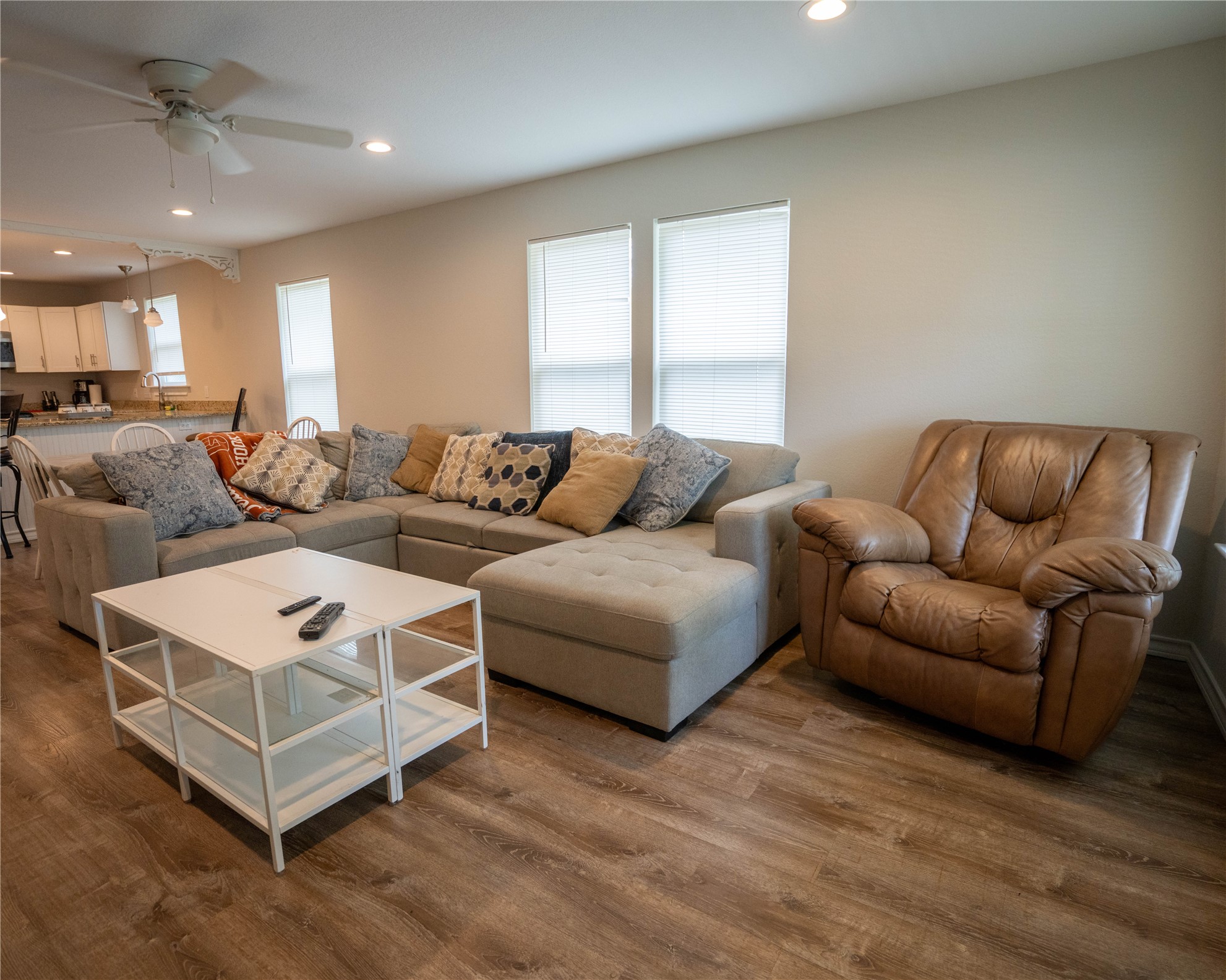 404 Rivers Street Smithville, TX 78957 - Photo 9 of 27 Open concept living area featuring wood-finish flooring, recessed lighting, and a ceiling fan