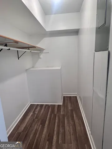 a view of a room with wooden floor