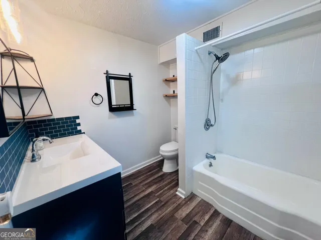 a bathroom with a sink toilet and shower