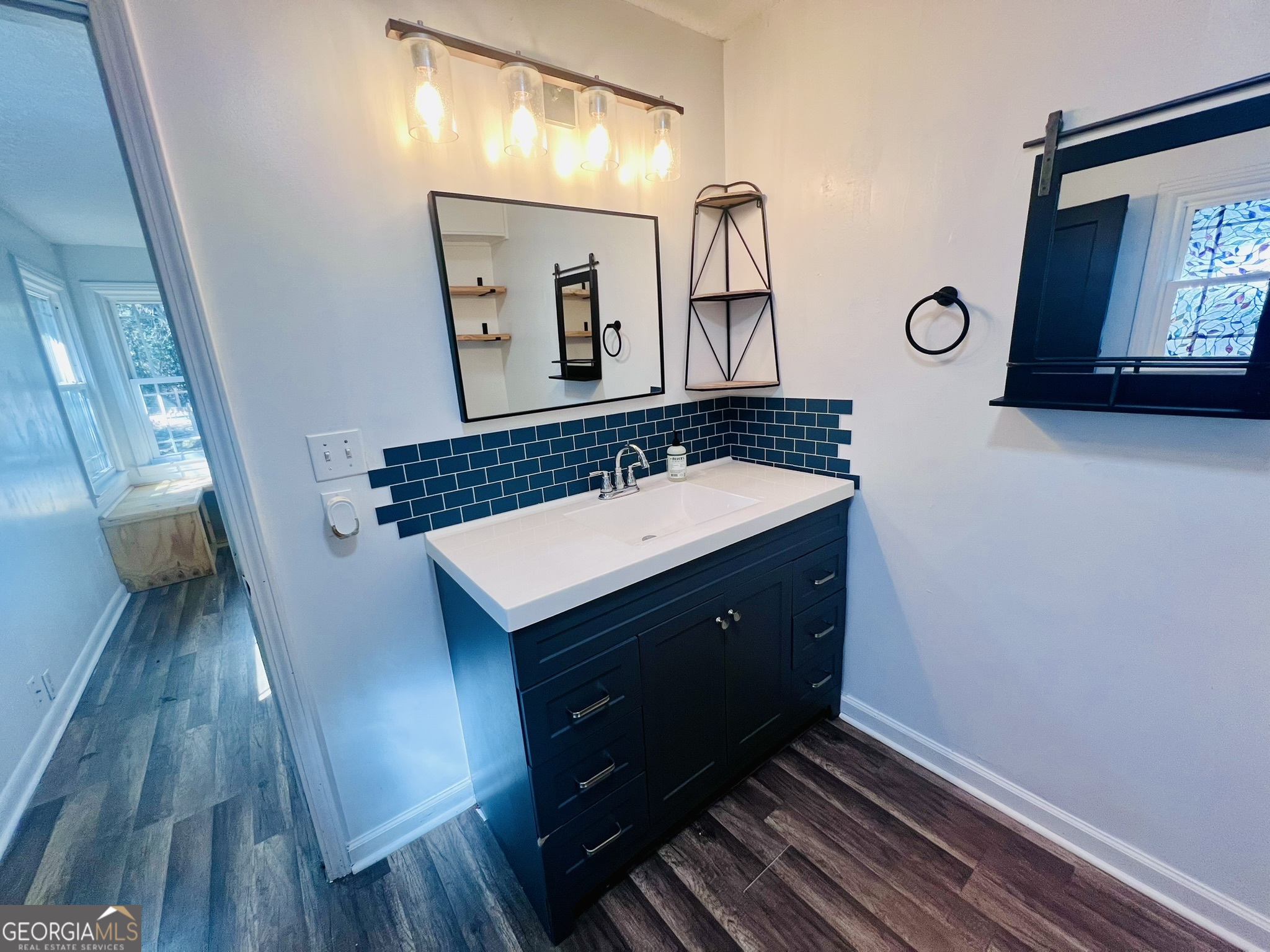 594 South 3rd Street Jesup, GA 31545 - Photo 22 of 32 a bathroom with a sink and a mirror