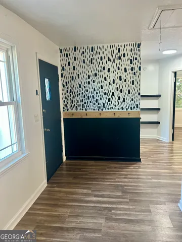 a view of wooden floor and windows in a room