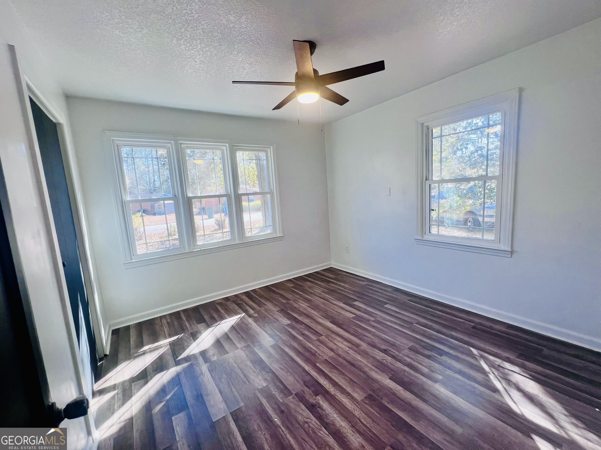 594 South 3rd Street Jesup, GA 31545 - Photo 6 of 32 a view of an empty room with wooden floor and a window