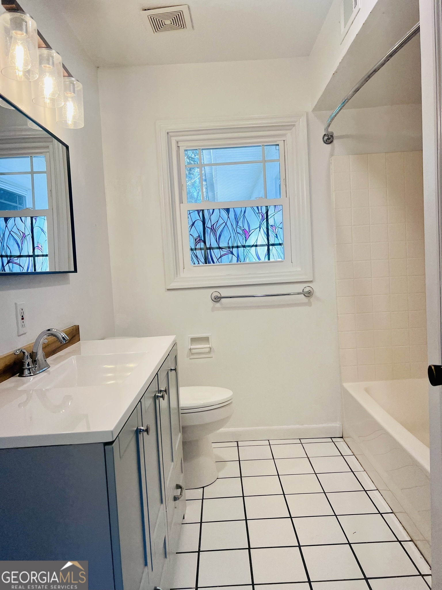 594 South 3rd Street Jesup, GA 31545 - Photo 8 of 32 a bathroom with a sink a toilet and shower