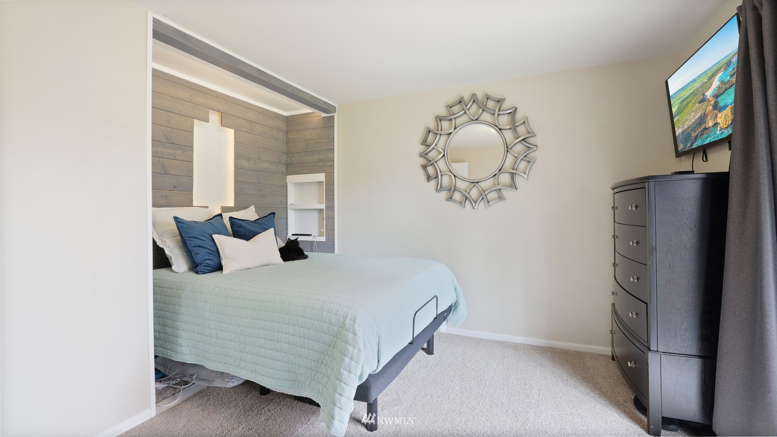 123 234th Street Southwest Bothell, WA 98021 - Photo 24 of 38 a bedroom with a bed and a chandelier