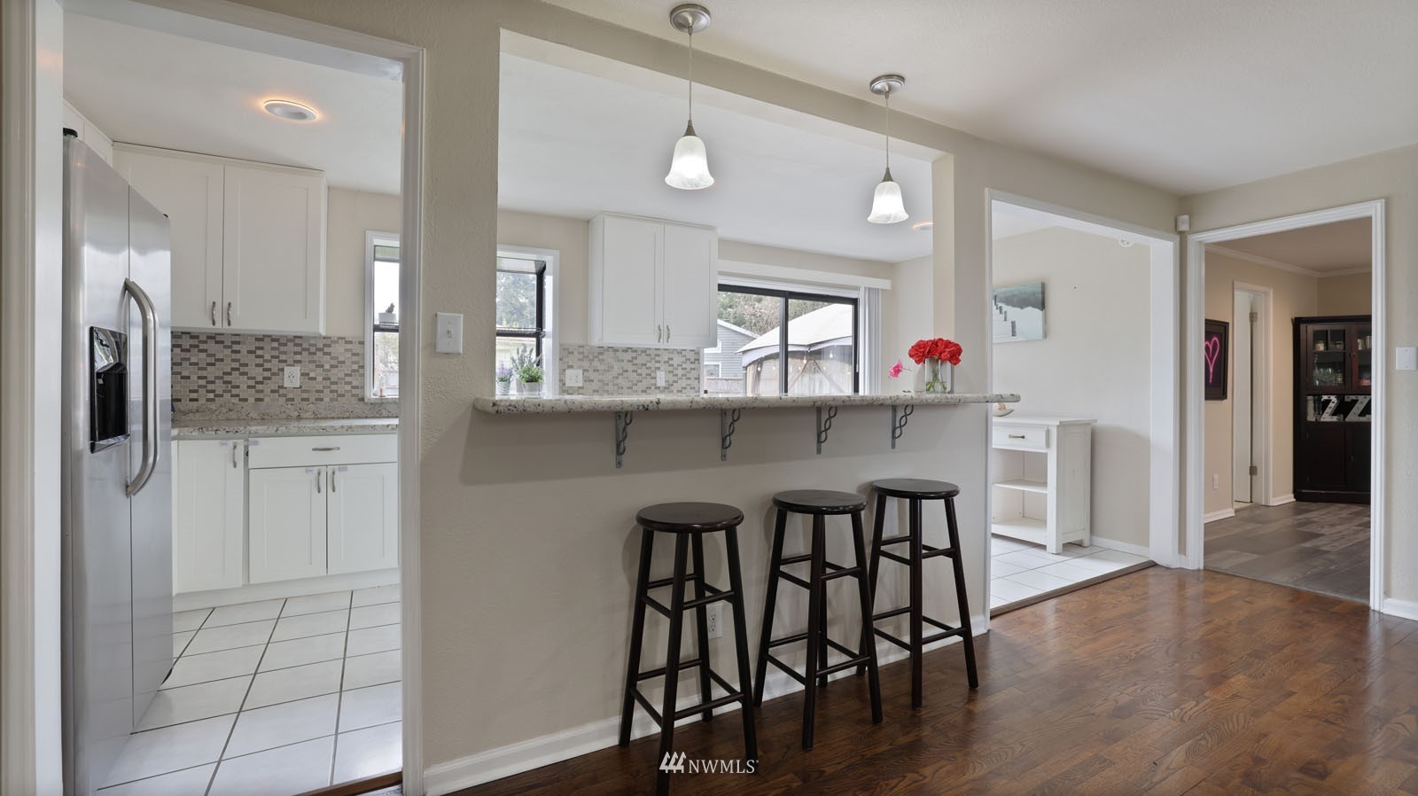 123 234th Street Southwest Bothell, WA 98021 - Photo 5 of 38 a kitchen with stainless steel appliances a dining table chairs and wooden floor