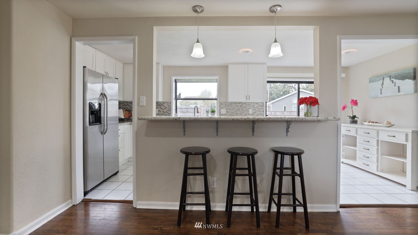 123 234th Street Southwest Bothell, WA 98021 - Photo 7 of 38 a kitchen with stainless steel appliances a dining table chairs and wooden floor