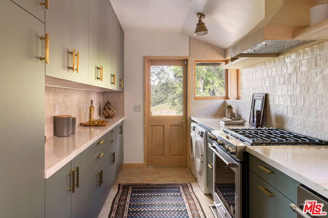2006 El Moran Street Los Angeles, CA 90039 - Photo 12 of 35 a kitchen with stainless steel appliances granite countertop a sink stove and refrigerator