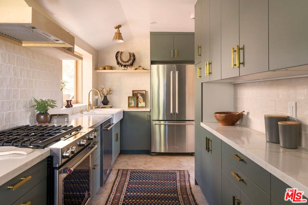 2006 El Moran Street Los Angeles, CA 90039 - Photo 13 of 35 a kitchen with stainless steel appliances granite countertop a sink stove and refrigerator