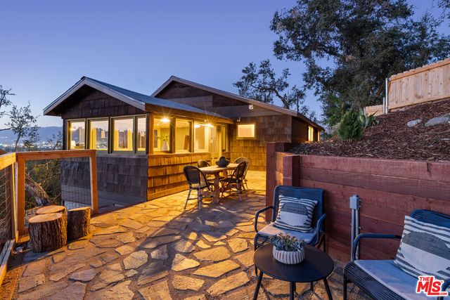 a view of a patio with table and chairs with wooden floor and fence