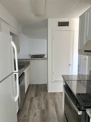 a kitchen with a refrigerator sink and stove