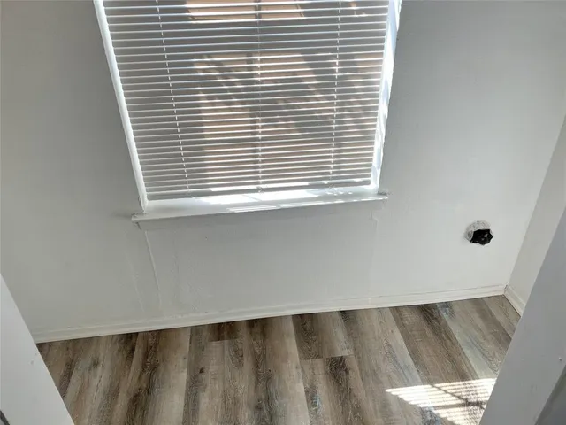 a bathroom with a granite countertop toilet and a sink